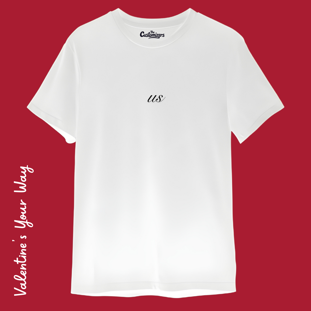Front view of a custom white t-shirt by The Customizers with a small, black "us" script centered on the chest.